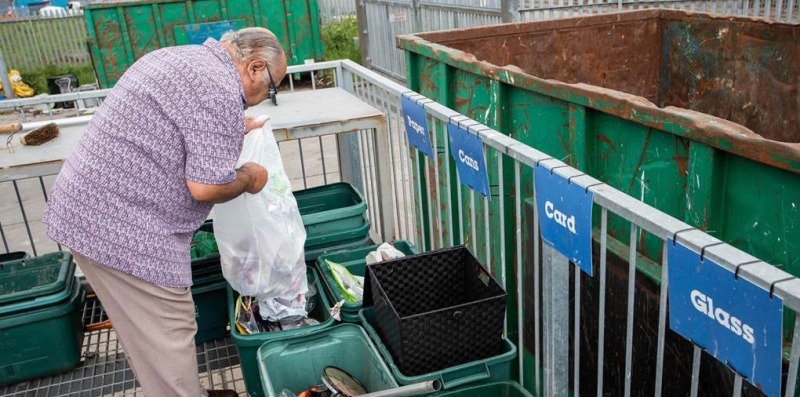A resident sorting waste at an HWRC