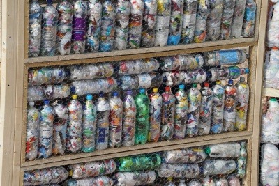 Image of a wall made of waste plastic eco bricks like the ones WasteAid trains communities to make
