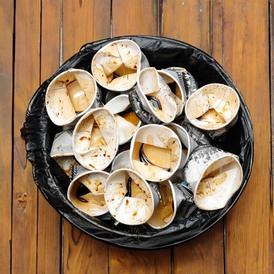 Single use cups in a bin