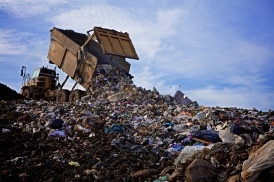A truck tipping waste into a landfill