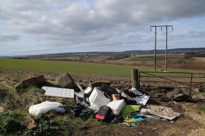 Fly-tipping waste by the side of the road