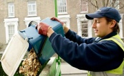 Food waste caddy being emptied by operative