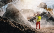 Woman in high-vis at an industrial composting site