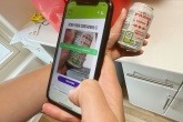 Someone scanning a QR code on side of a can in the Brecon digital deposit return scheme trial