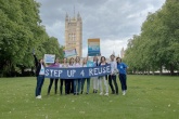 CityToSea campaigners stood in a park holding banners to promote World Reuse Day
