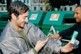 Man using smartphone app to use AI detection to claim a deposit on a returned paper coffee cup