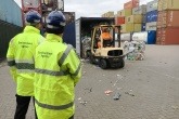 Environment Agency officers checking shipping container that has recycling materials for export
