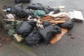 Pile of household and building waste fly-tipped at Haigh Park, Stockport