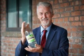 Huw Irranca-Davies holding a glass bottle 