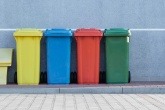 Four bins, from left to right – yellow, blue, red, and green