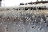 Plastic flakes falling down a conveyor belt