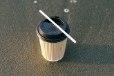 An image of a paper coffee cup on the ground