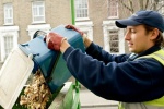 Food waste caddy being emptied by operative