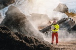 Woman in high-vis at an industrial composting site